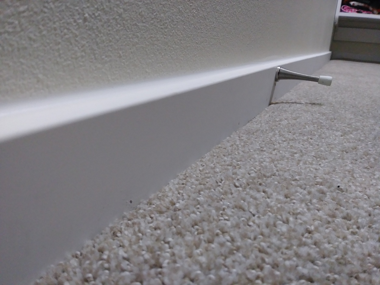 Finished baseboard installation along carpet edge, Seattle home