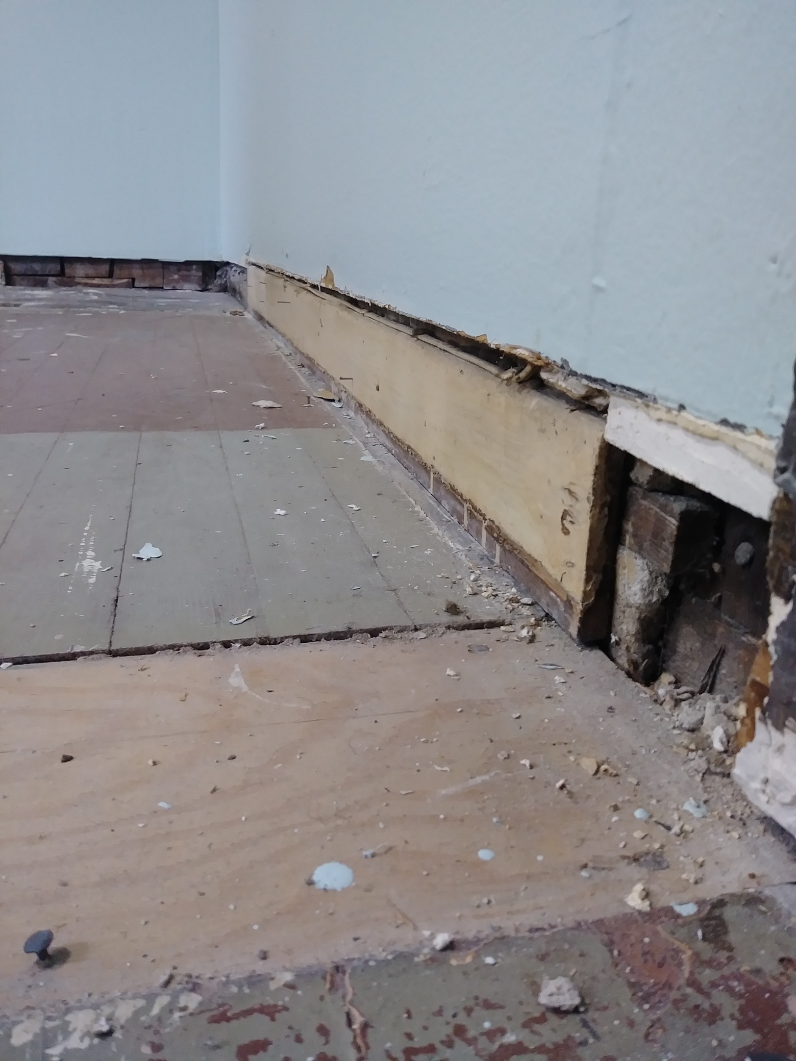 Damaged wall base before baseboard replacement, Seattle