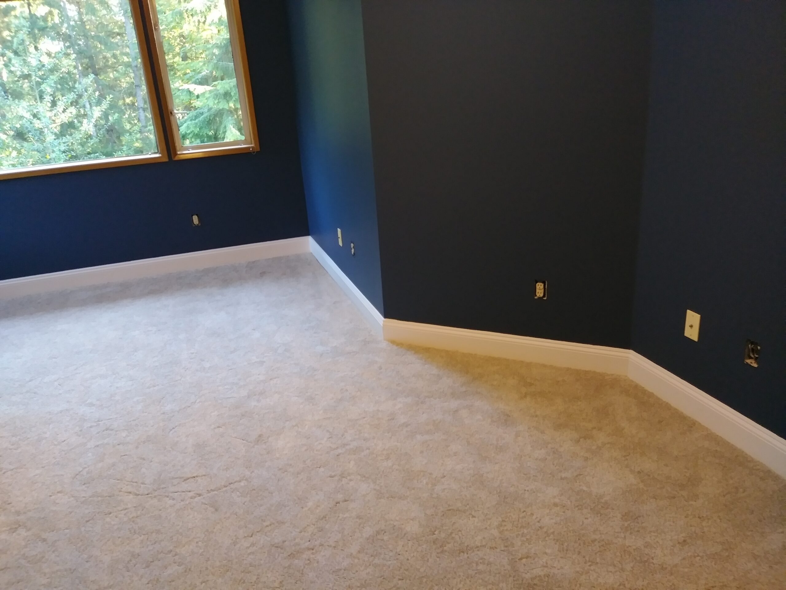 Finished baseboard installation in bedroom corner, Seattle home