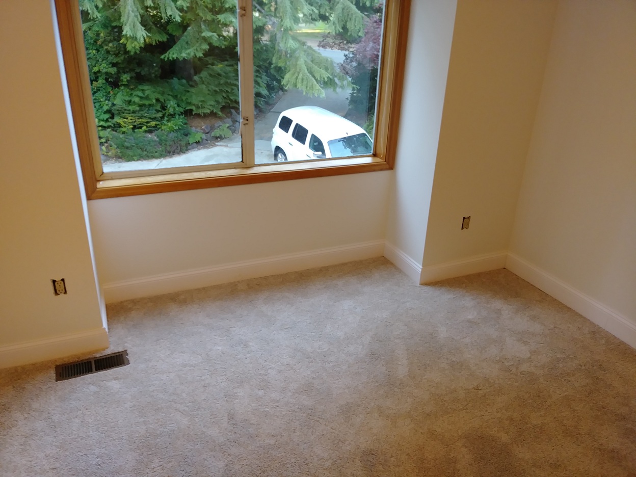 Completed baseboard trim in sunlit room, Seattle home