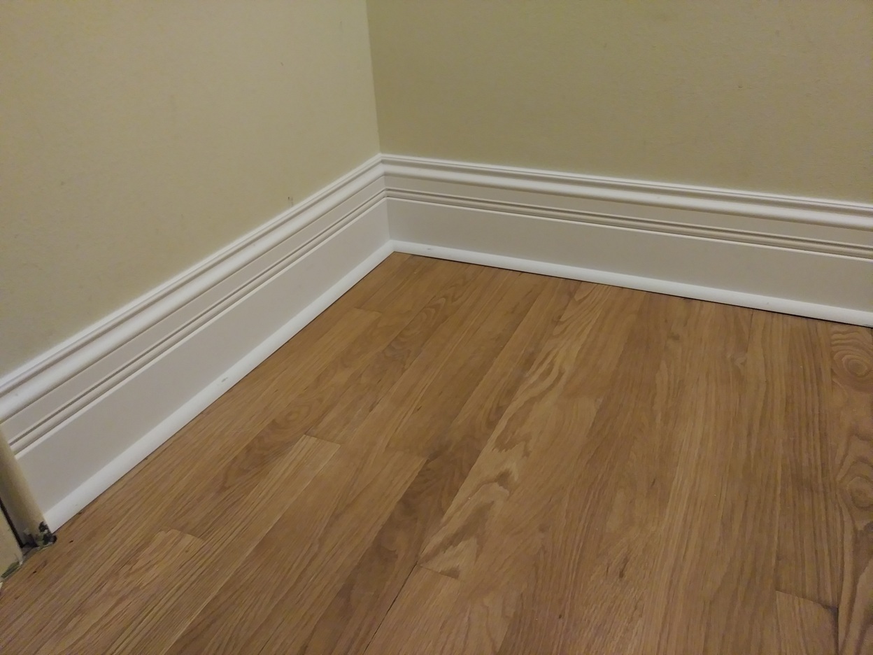 White baseboard installed on hardwood floor, Seattle home
