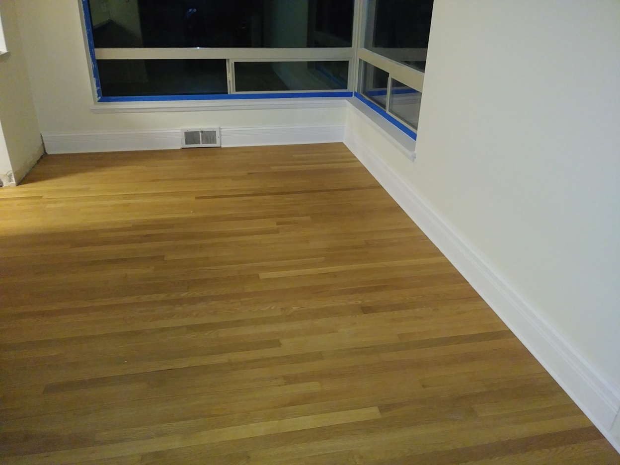 Completed baseboard trim with hardwood flooring, Seattle home