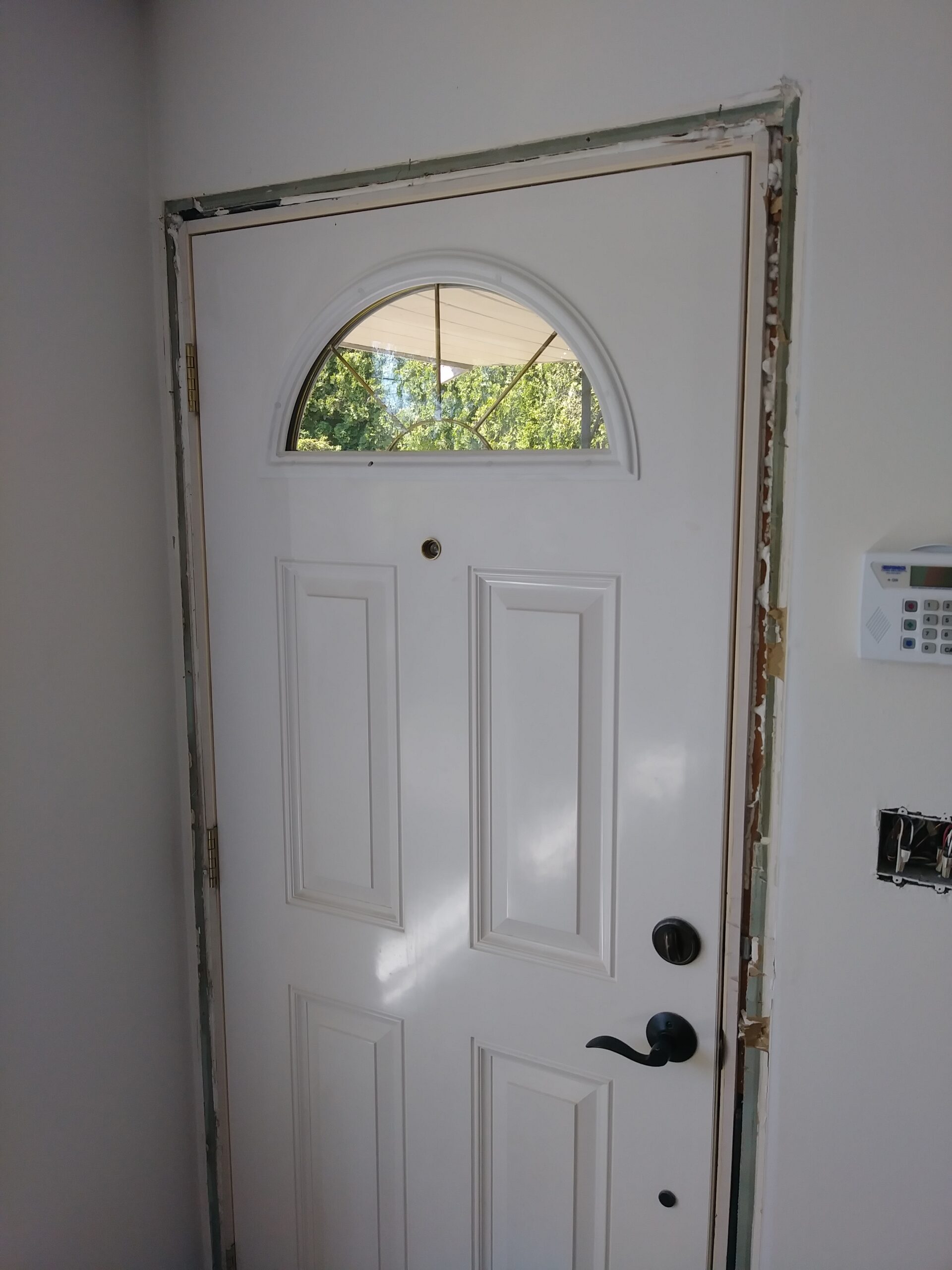 Front door before casing installation, arched transom window