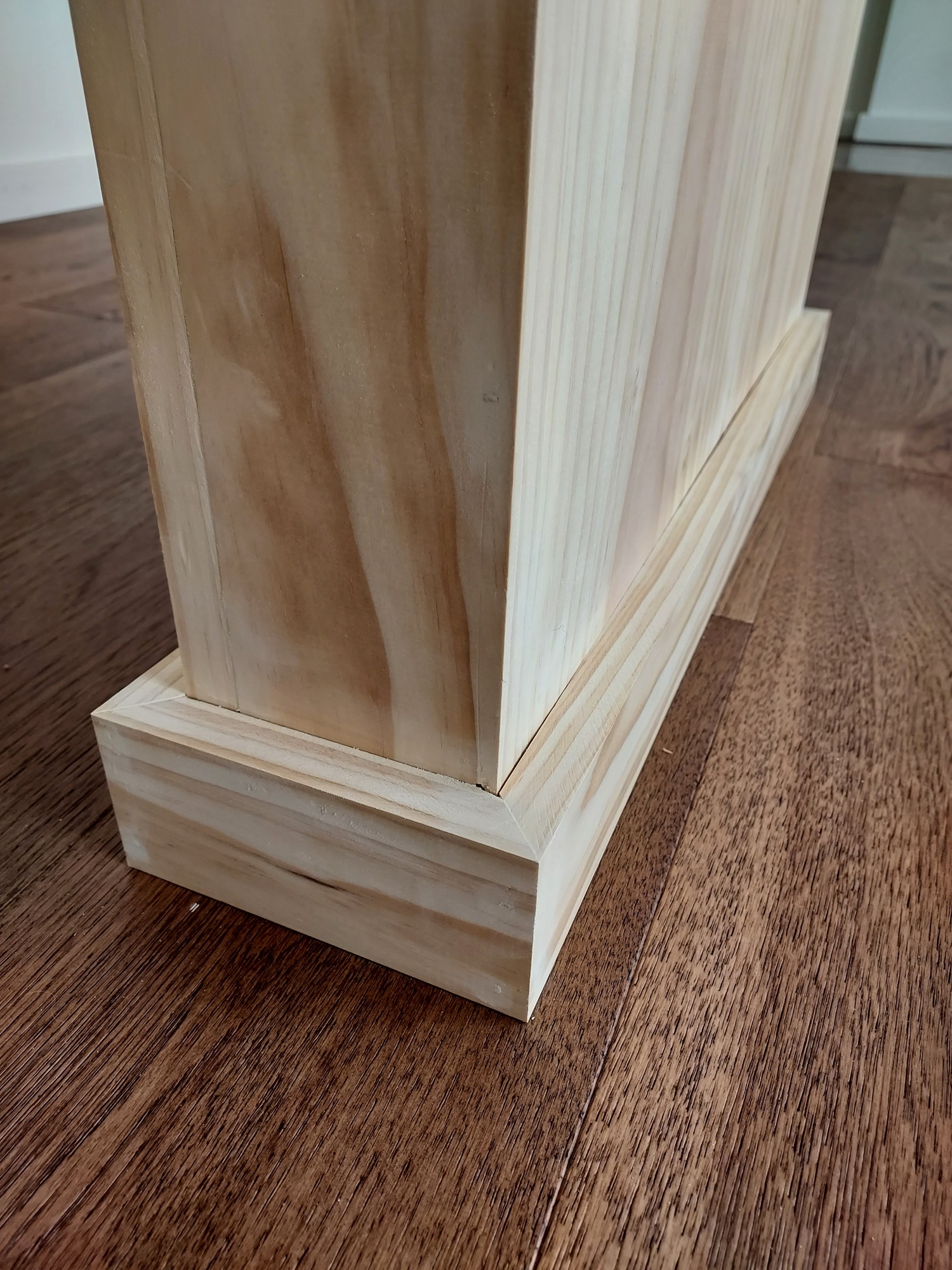 Decorative column installation detail, hardwood floor, Seattle home