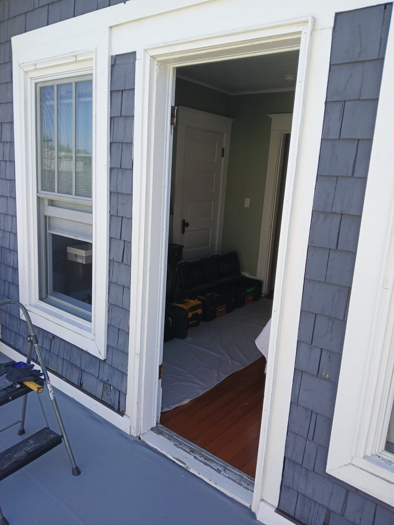 Exterior door before replacement, blue siding, Seattle