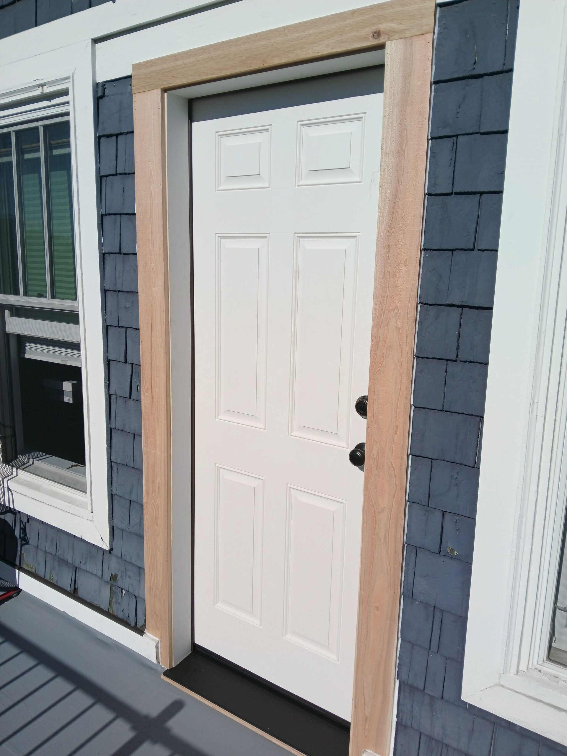 New exterior door installed, blue siding, Seattle home