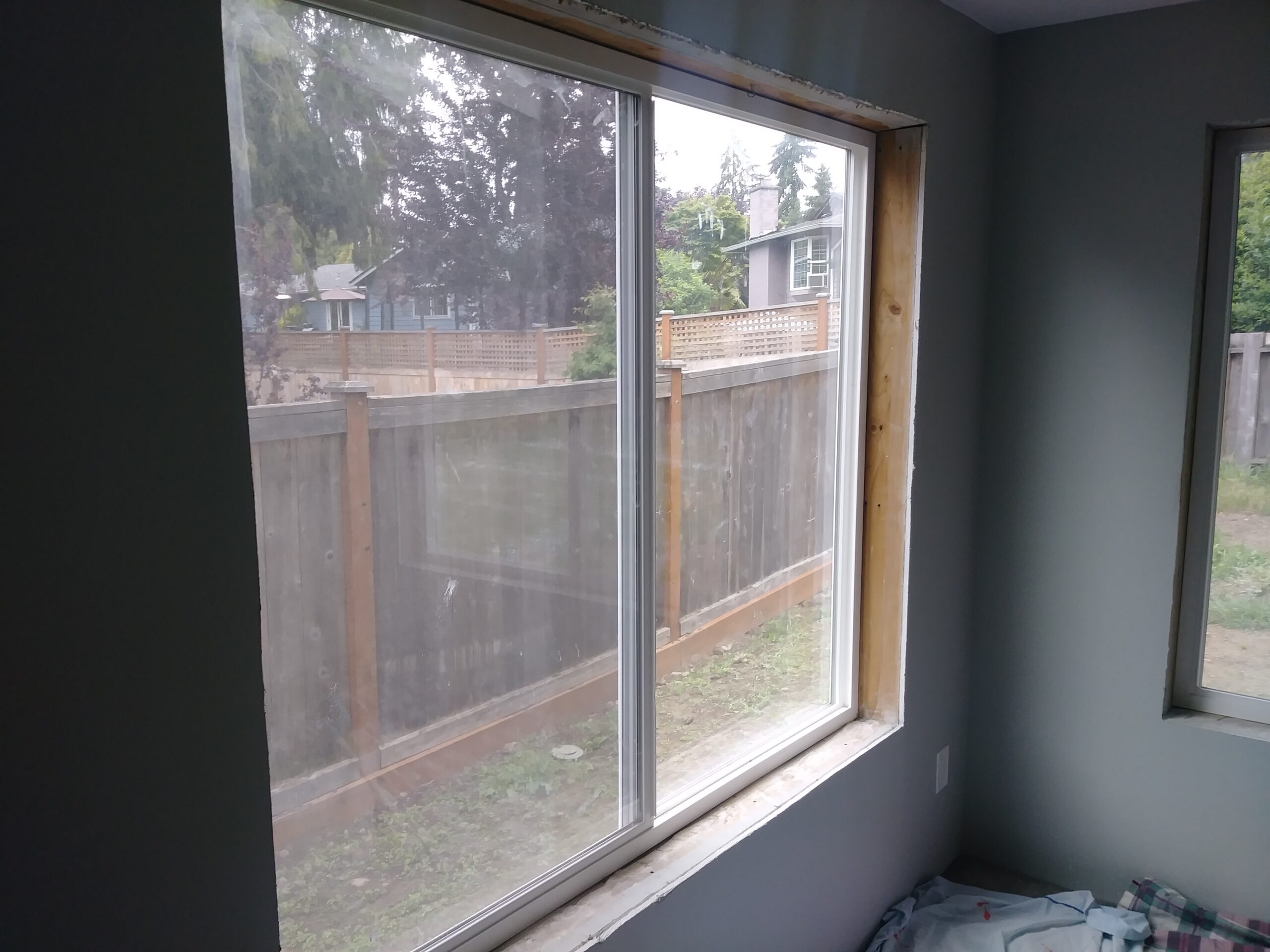 Window before casing installation, dark accent wall, Seattle