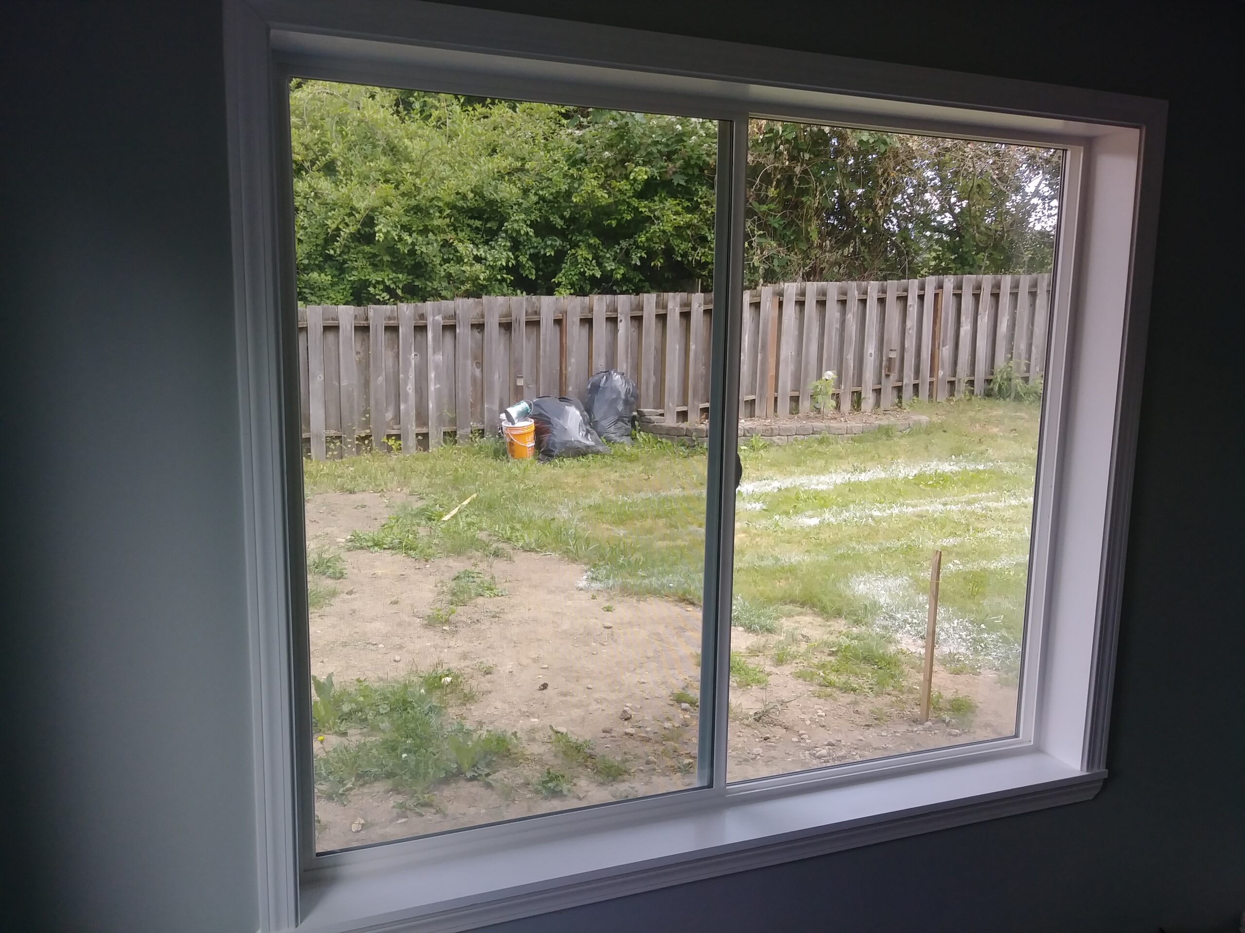 Completed window casing on large picture window, Seattle home