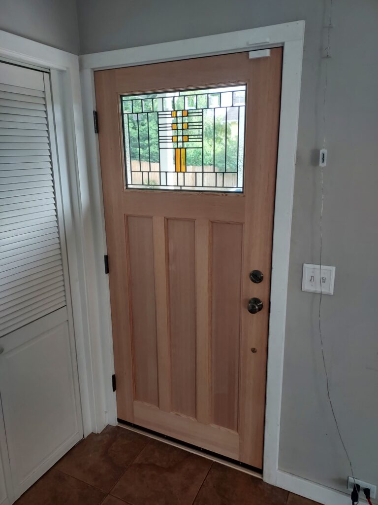 New exterior door installed with casing and hardware, Seattle home