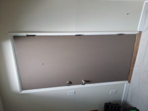 Existing gray exterior door before replacement, Seattle