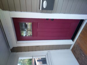 Dark red exterior door with glass insert installed, Seattle home