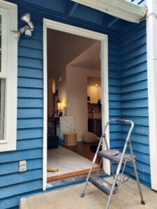 Blue house exterior before new entry door installation, Seattle
