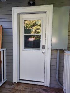 White exterior door with window installed, Seattle home