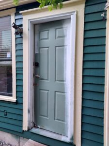 Teal house exterior with gray door during installation, Seattle