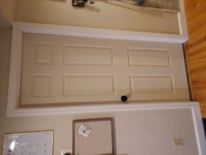 Natural wood interior swing door installed, Seattle home