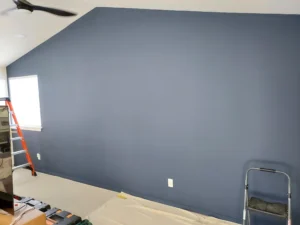Blue-gray painted wall before vertical wood slat accent installation
