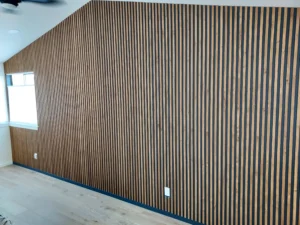 Completed dark vertical wood slat accent wall installed, Seattle home