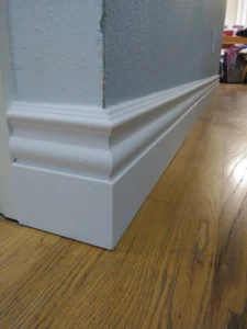 White baseboard molding installed at wall corner, Seattle home