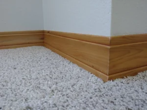 Carpeted room before baseboard molding installation, Seattle