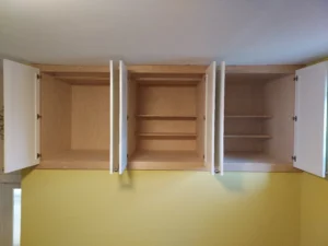 Custom built-in shelving unit mid-installation, white finish
