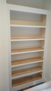 Tall white custom built-in bookcase with open shelving, Seattle