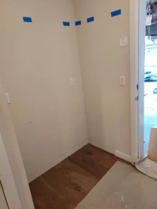 Wall framing with blue tape layout markings before built-in installation