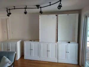 White cabinet frames staged before installation, Seattle project