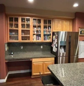Kitchen with glass-front upper cabinet boxes, pre-finish stage