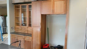 Finished kitchen with glass-front upper cabinets and wood lower cabinets, Seattle