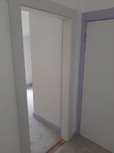 Interior door with white casing and trim installed, Seattle home