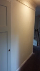 Bare wall before shadow box wainscoting installation, Seattle