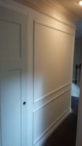 White shadow box panel molding installed on wall, Seattle home