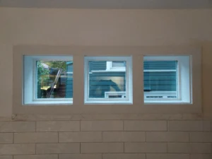 Triple window with new white interior casing installed, Seattle home