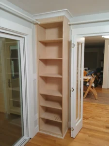 White painted custom built-in bookcase next to doorway, Seattle