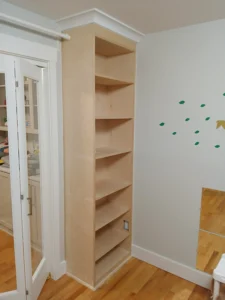 Tall white custom built-in bookcase installed in Seattle home
