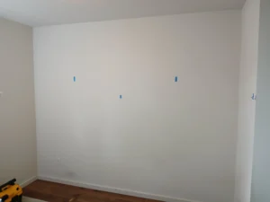 Plain wall before herringbone wood treatment installation, Seattle