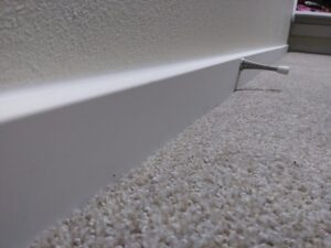 Finished baseboard installation along carpet edge, Seattle home