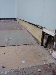 Damaged wall base before baseboard replacement, Seattle