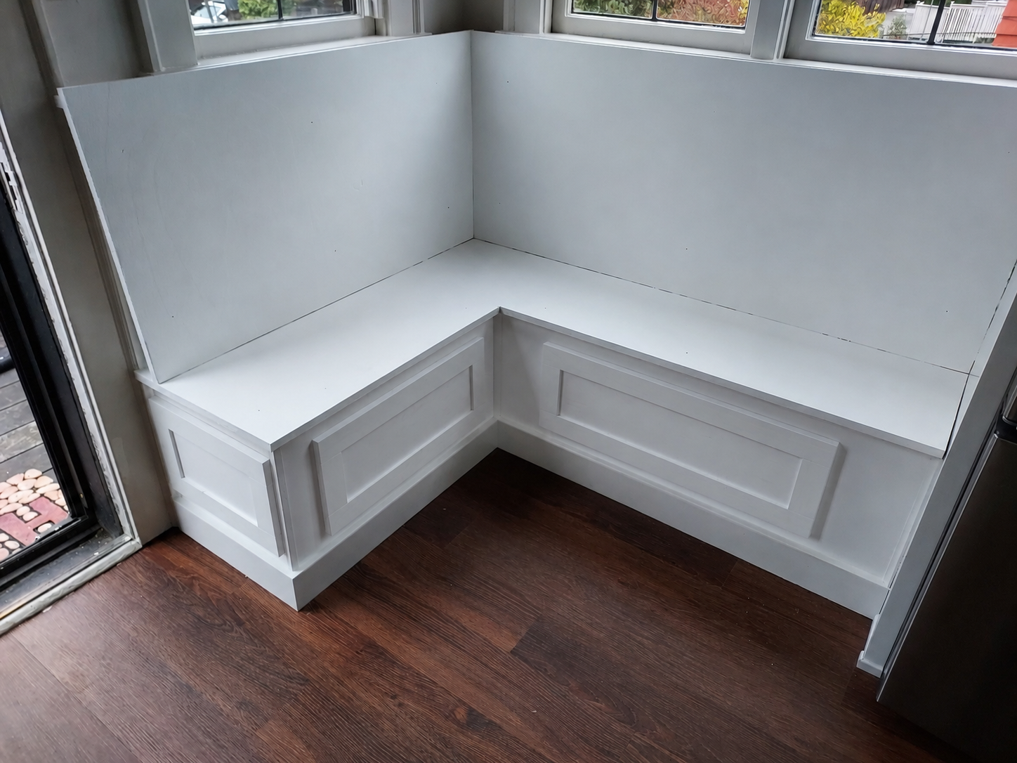 Finished white L-shaped window bench built-in installed, Seattle home