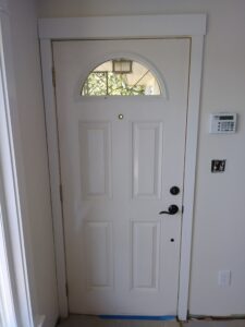 Exterior front door with arched transom casing installed, Seattle home