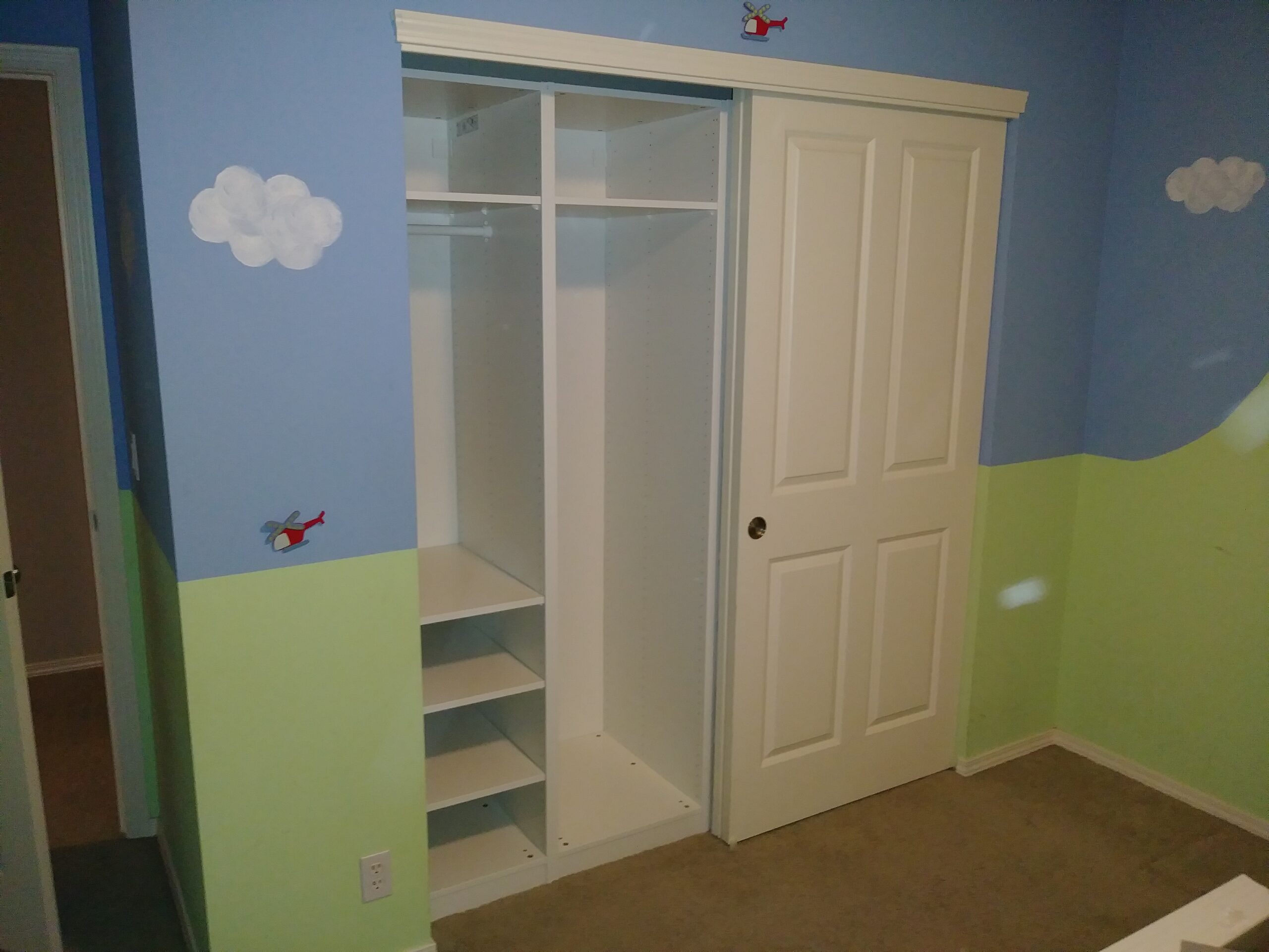 White built-in wardrobe with shelves installed in Seattle kids bedroom