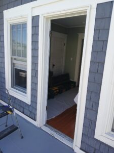 Exterior door before replacement, blue siding, Ballard